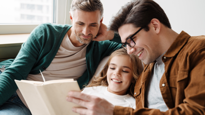 Parents reading adoption lifebook to child